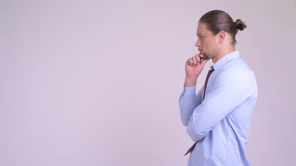 Profile View of Happy Handsome Businessman Thinking