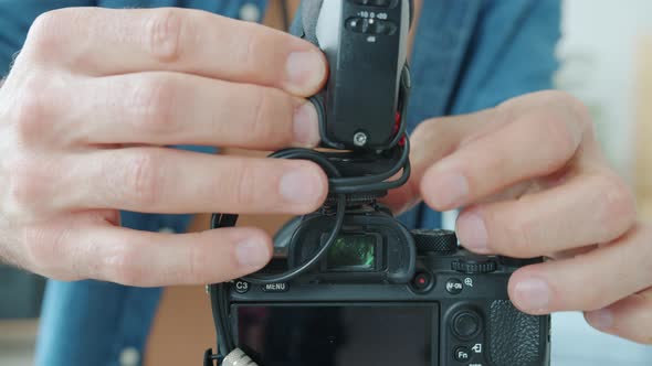 Closeup of Male Hands Working with Modern Camera While Blogger is Ready for Recording Video