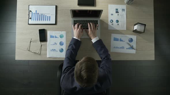 Busy Man Finishes Typing on Laptop, Leaving Office at Working Day End, Top View