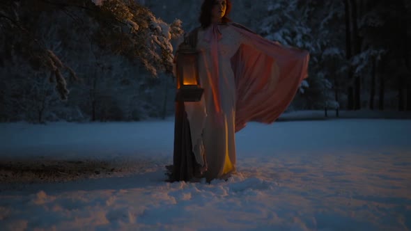 Epic Fantasy Shot Young Woman Spinning Her Flying Cloak Holding Vintage Lantern in Snowy Forest at