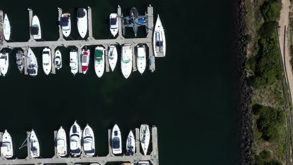 AERIAL Directly Above Luxury Yachts Moored In A Coastal Marina