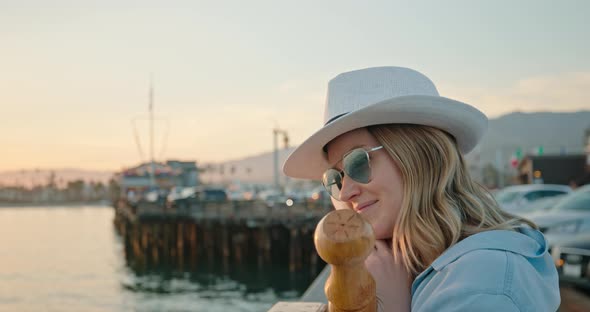 Close Up Portrait of Smiling Woman Enjoying Beautiful Rose Gold Sunset at Ocean