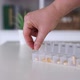 Hand Put Pills to Medical Pill Box Tablet Doses for Daily Take Drugs Capsules - VideoHive Item for Sale