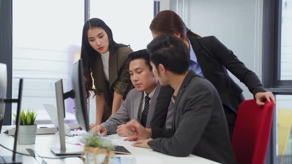 Asian young business people brainstorming and working on project together as teamwork in office.