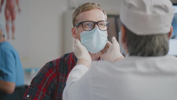 Doctor Examines with Fingers Neck of Patient