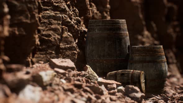 Old Wooden Vintage Wine Barrels Near Stone Wall in Canyon