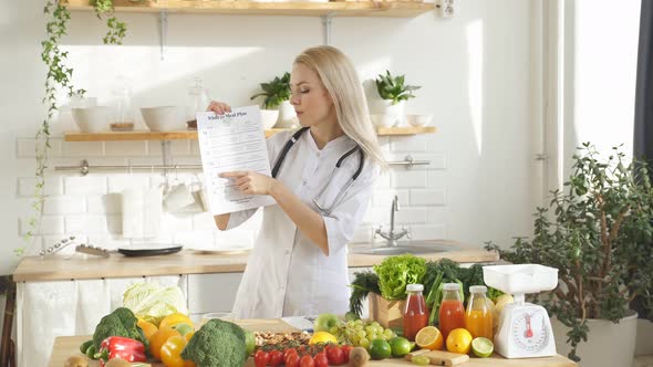 Woman Stands at a Table with a Lot of Vegan Food Ingredients She Talks About Proper Nutrition at