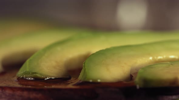 Squeezing Lemon and Olive Oil on Avocado in Slow Motion