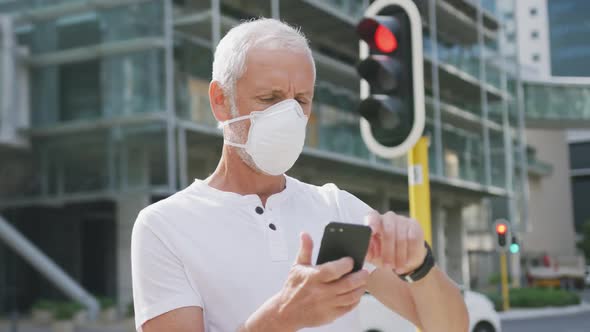 Caucasian man out and about in the street wearing on a face mask against coronavirus