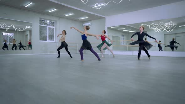 Wide Shot Smiling Slim Gorgeous Ballerinas Doing Pirouettes in Dance Studio Indoors