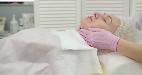 Beautician Making Skin Care Procedure In Beauty Salon, Close Up Portrait Of Girl