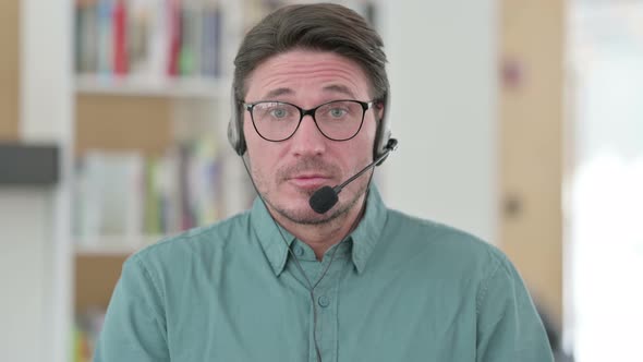 Middle Aged Man Talking on Headset
