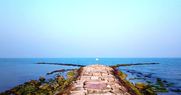 Motion Along Large Sea Rock Mass Forming Mole Against Sea