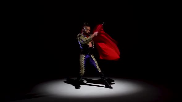 Torero in Blue and Gold Suit or Typical Spanish Bullfighter Isolated Spotlight on a Black Background