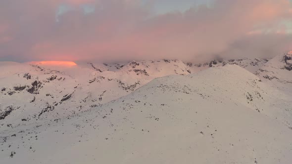 Aerial drone footage of snowy mountain peaks.