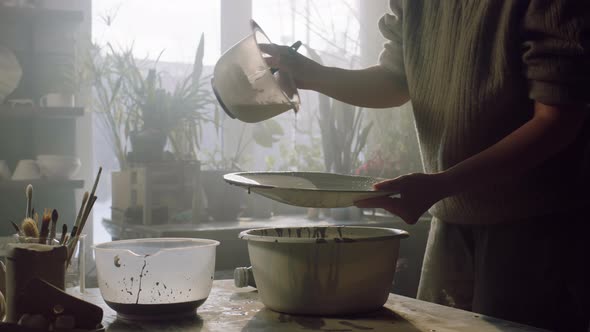 Woman Is Covering Ceramic Plate With Glaze