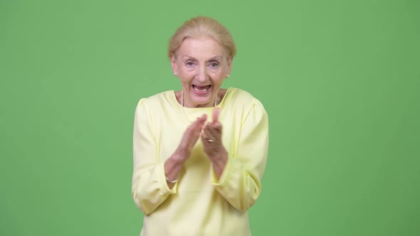 Happy Senior Businesswoman Clapping Hands