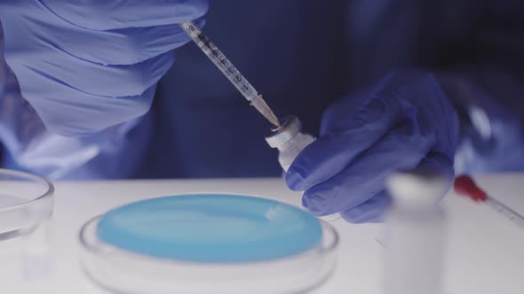 Virologist Using Syringe in Lab