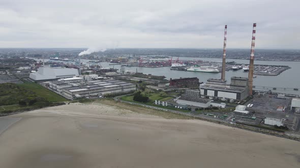 Poolbeg Generating Station (Poolbeg Stacks) At Dublin Port In Dublin, Ireland. aerial drone orbit