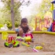 A small girl sitting in a sandbox - VideoHive Item for Sale