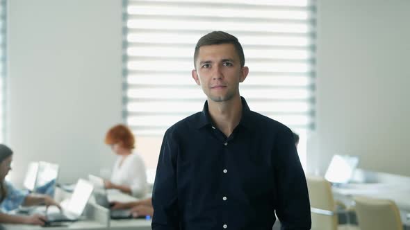 Successful Man in the Office Looking at the Camera and Smiling