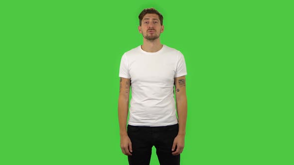 Confident Guy Is Smiling and Showing Heart with Fingers Then Blowing Kiss. Green Screen