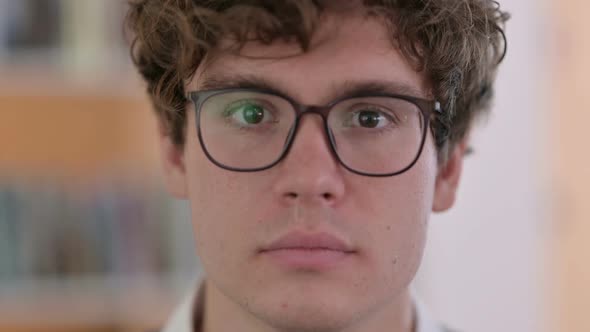 Close Up of Face of Serious Young Man Looking at Camera