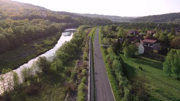 sunset roller skating on the long lonely road aerial shot