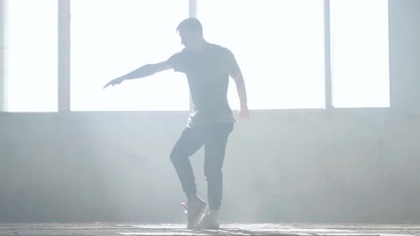 Confident Young Passionate Hip-hop Dancer Performing in the Fog