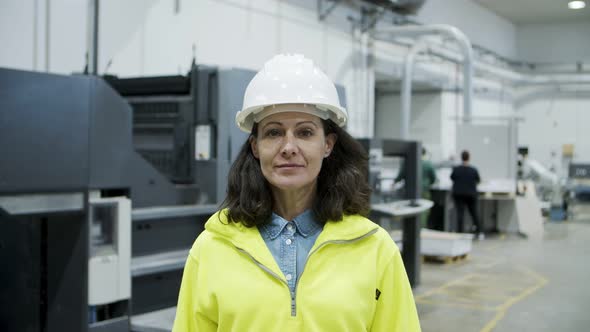 Smiling Female Technician Looking at Camera