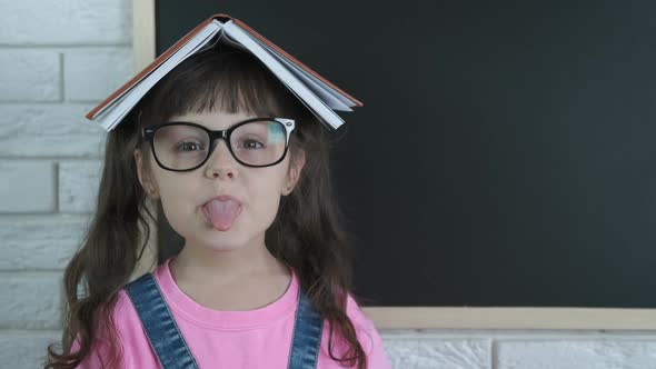 A Child with a Book on Head