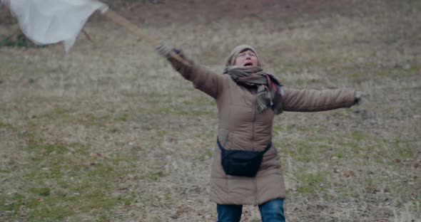 Distraught Woman Waving White Flag During War