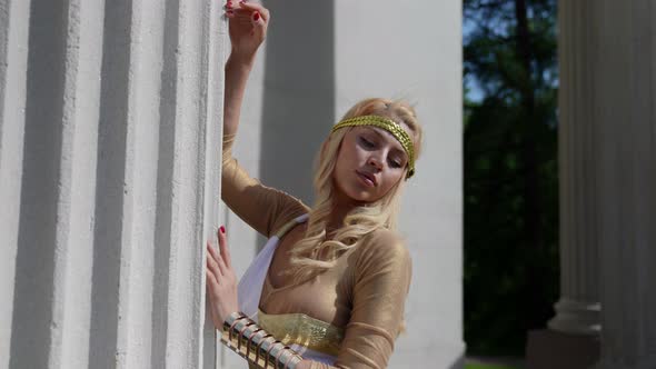 Portrait of a Blonde with Big Breasts and in a Greek Chiton at the Column