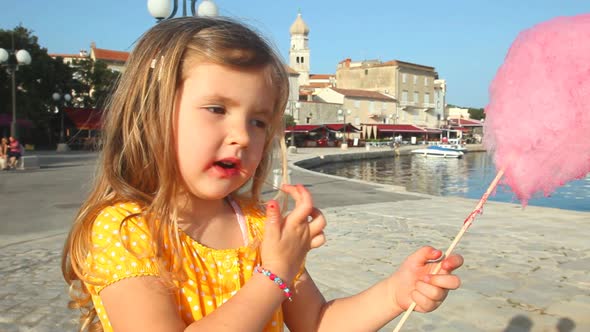 girl eating candy floss