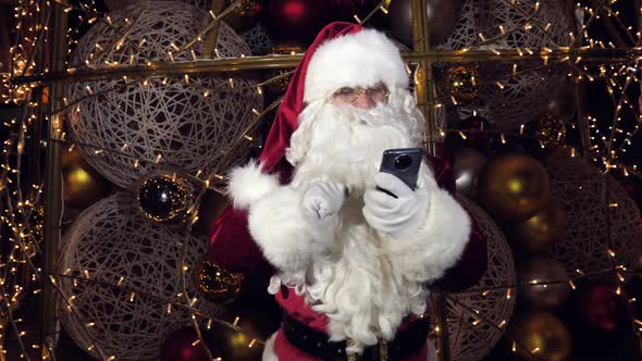 Happy Santa Claus Saint Nicholas Makes a Video Call to the Child or Records a Virtual Greeting on