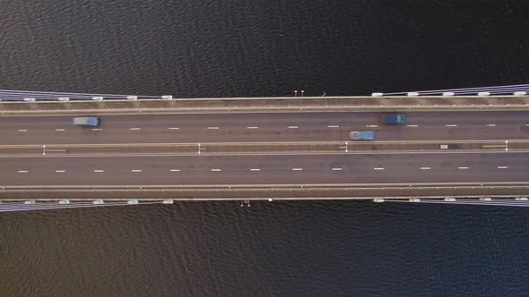 Vehicles Driving Across a Bridge Crossing a River