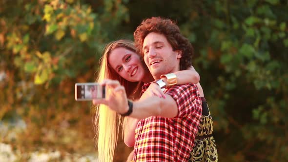 Cute young couple taking selfies and laughing