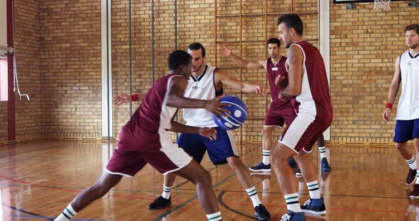 Basketball players playing in the court