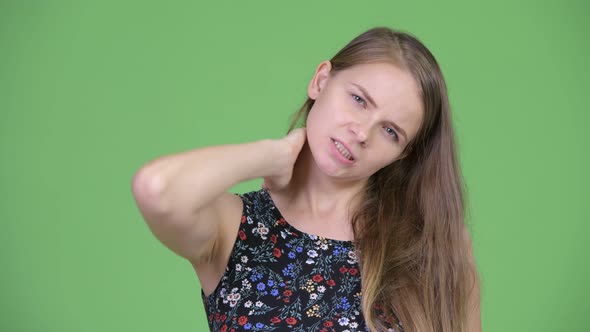 Head Shot of Young Stressed Woman Having Neck Pain