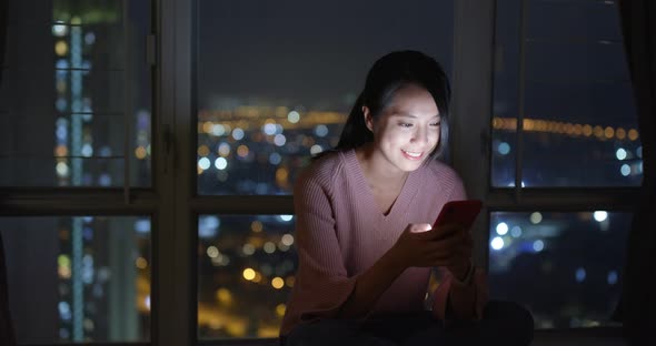 Woman look at mobile phone in the evening