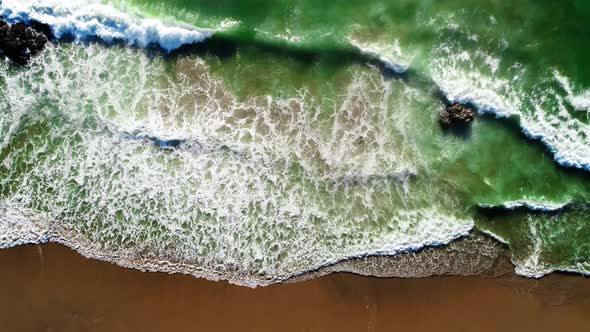 Tropical Sea Waves Hitting Sandy Beach with Sun Reflection, Aerial Top Down View