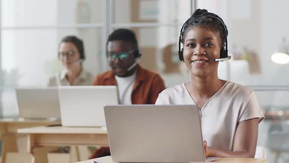 Portrait of Cheerful Afro-American Woman at Work in Call Center