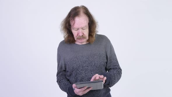 Happy Senior Man with Mustache Using Digital Tablet