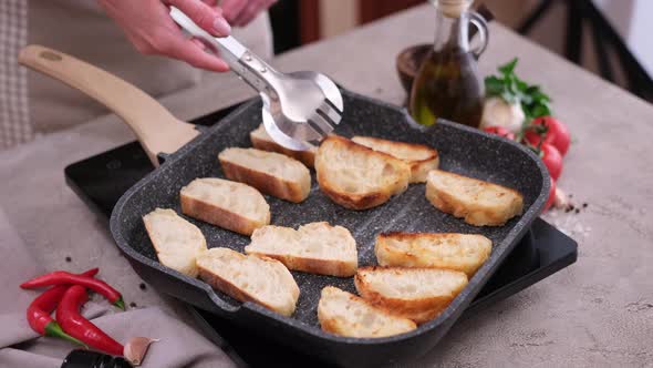 Toasting Slices of Baguette in a Grill Frying Pan