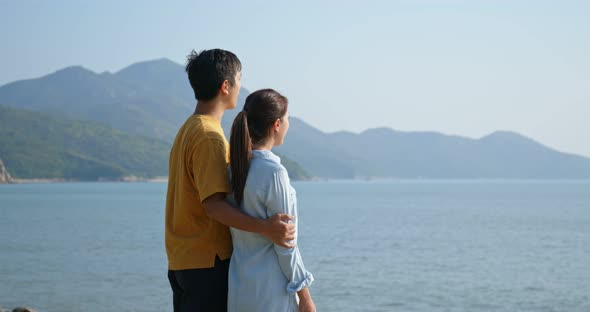 Couple look at the sea together