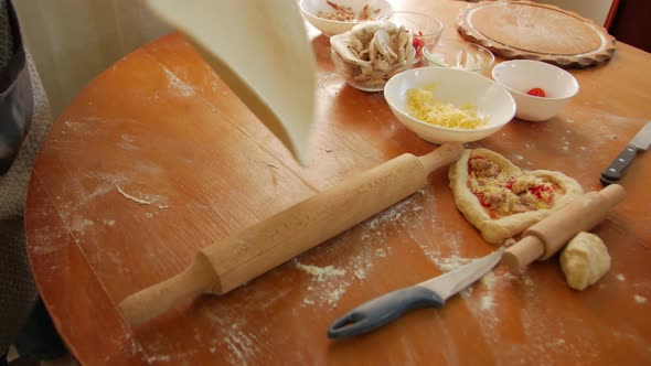 Woman Rolling Pizza Dough