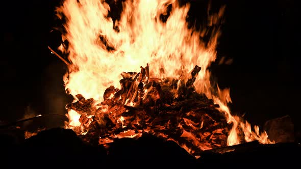 Big Bonfire Burns at Night on a Black Background