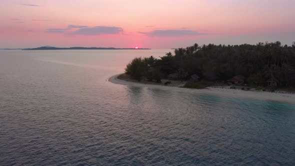 Aerial sunset: flying over exotic tropical island secluded destination away from it all