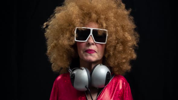 Senior Woman Dancing in Disco with Headphones