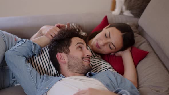 Romantic couple relaxing on couch